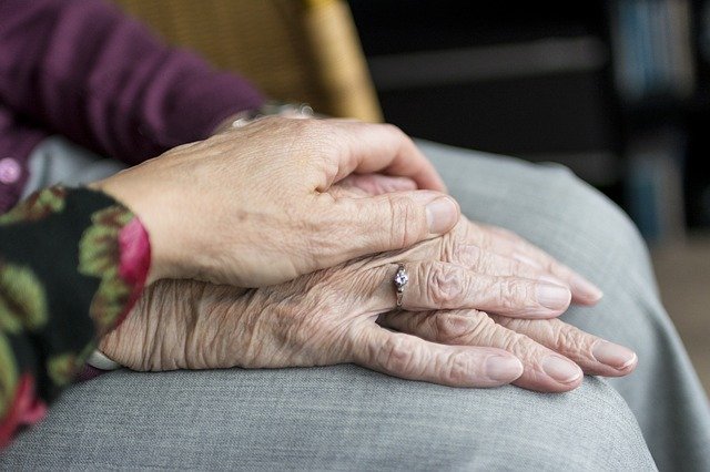 Dementia patient holding hands